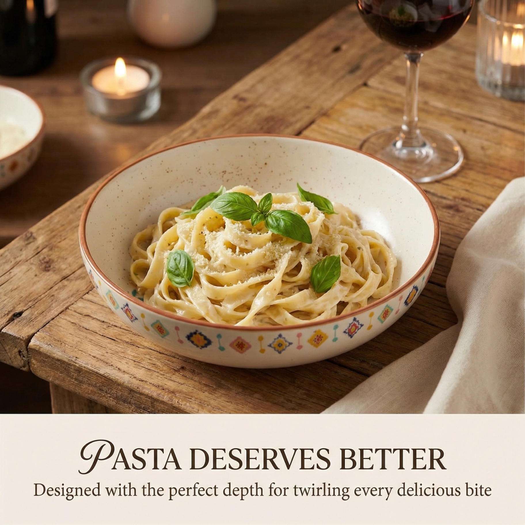 Fine dining setup featuring fettuccine in a handcrafted bowl with candlelight and wine